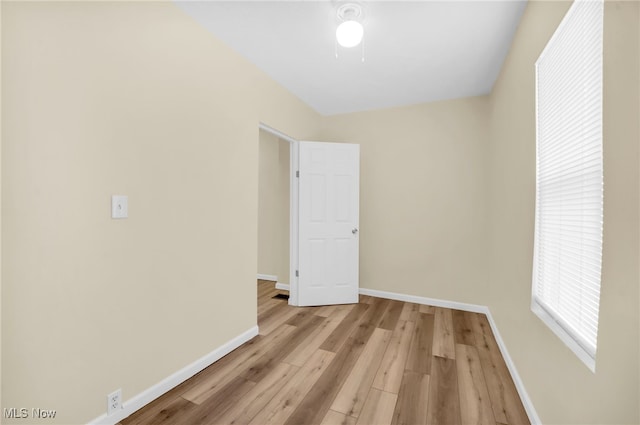 unfurnished room with light wood-style flooring and baseboards