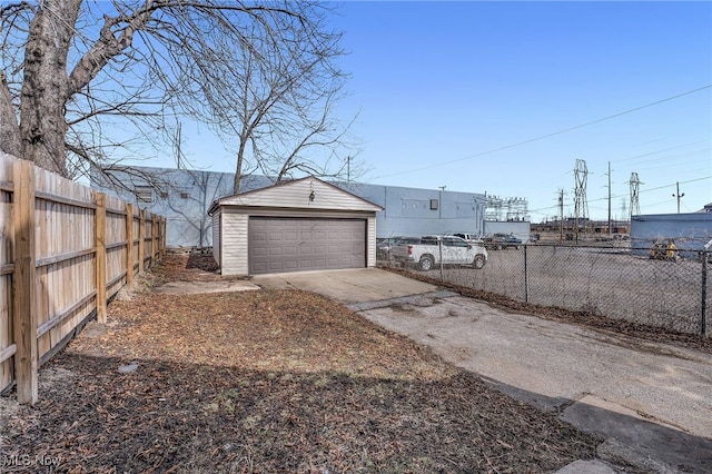 detached garage featuring fence