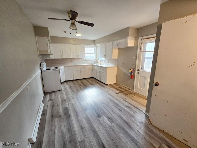 kitchen featuring white range with electric cooktop, tasteful backsplash, ceiling fan, and wood finished floors