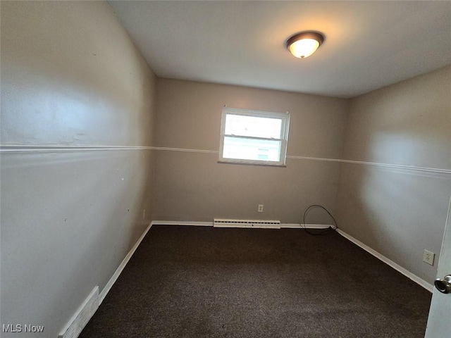 carpeted empty room featuring a baseboard heating unit and baseboards