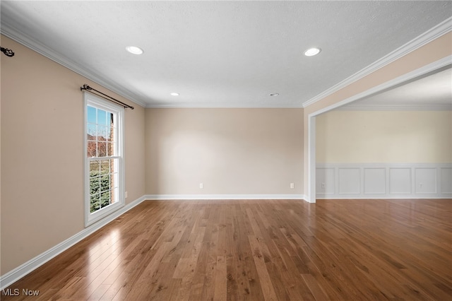 unfurnished room with recessed lighting, baseboards, wood-type flooring, and ornamental molding