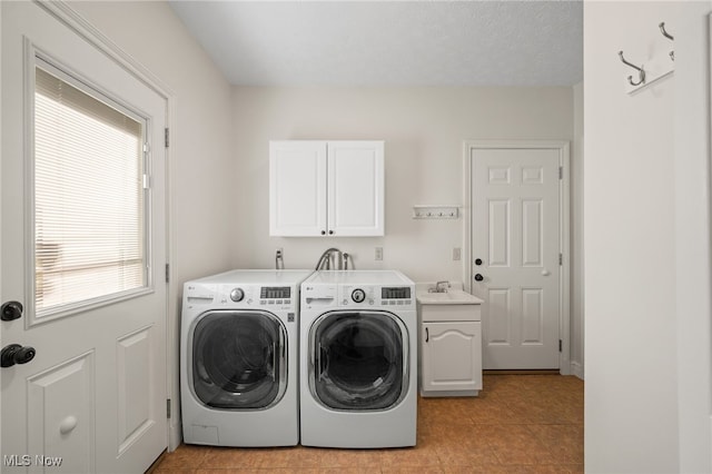 clothes washing area with cabinet space and separate washer and dryer