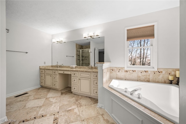 bathroom featuring a shower stall, a bath, visible vents, and a textured ceiling