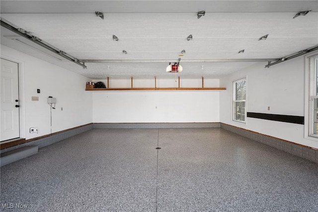 garage with baseboards and a garage door opener