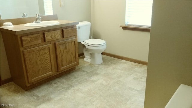 bathroom with vanity, tile patterned floors, toilet, and baseboards