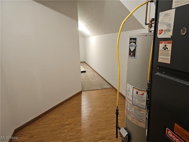 utility room featuring gas water heater and heating unit