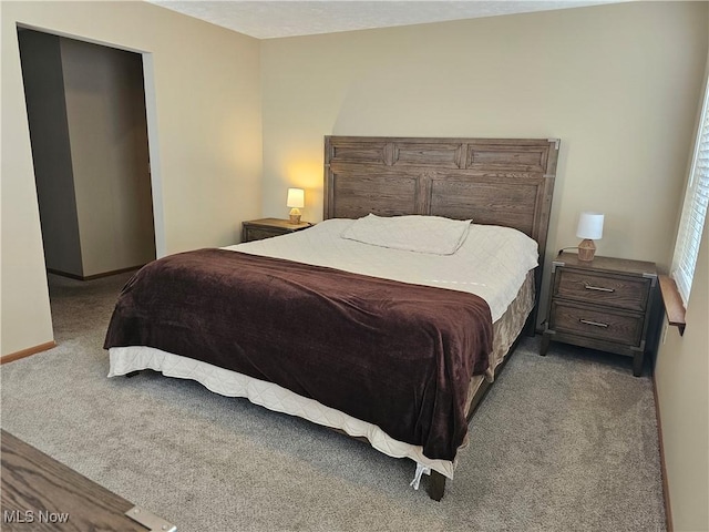 bedroom with carpet flooring and baseboards