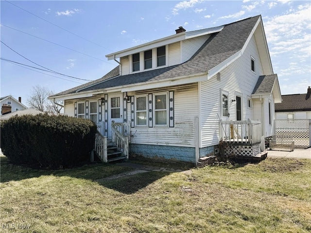 bungalow-style house with a shingled roof, a front lawn, and a chimney