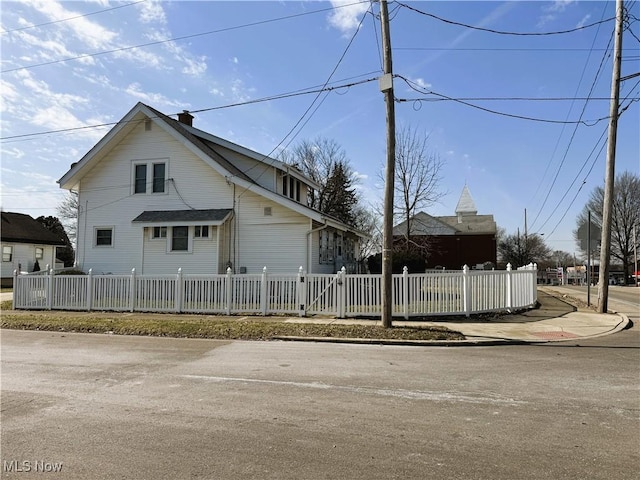 view of front of house with a fenced front yard and a chimney