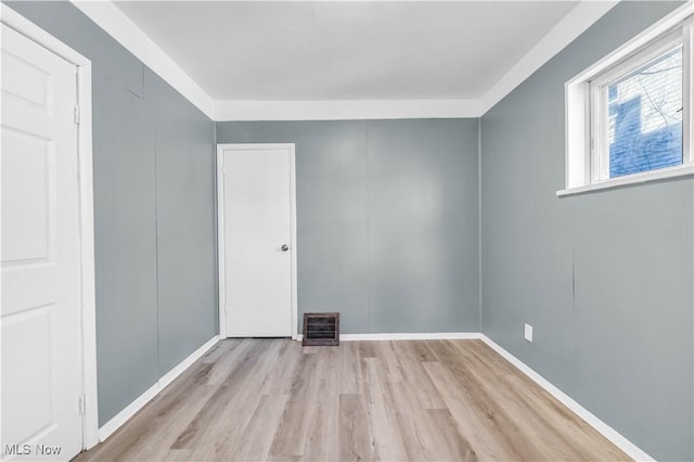 empty room with wood finished floors and visible vents