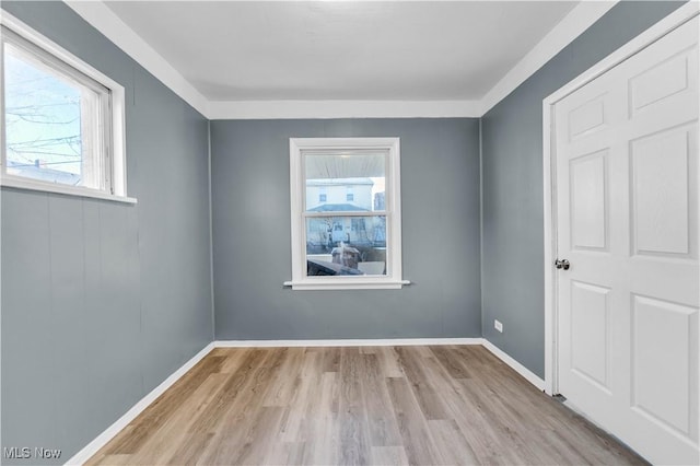 spare room with wood finished floors and baseboards