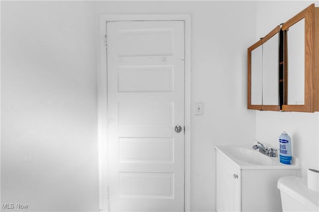 bathroom featuring toilet and vanity