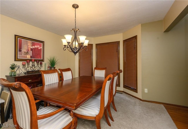 dining space with baseboards and an inviting chandelier