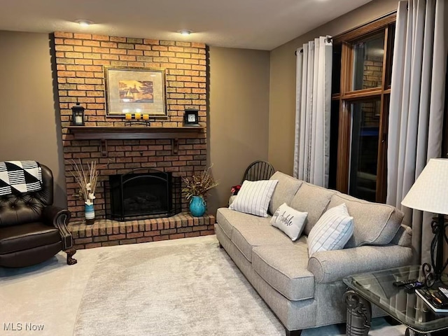 living area featuring a fireplace and carpet floors