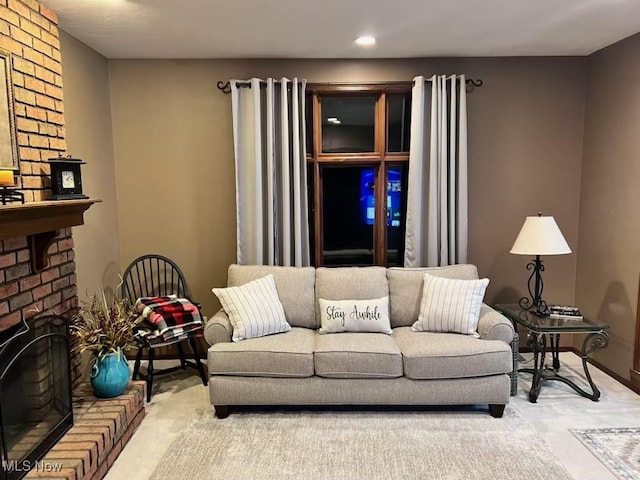 living room featuring baseboards, carpet floors, and a brick fireplace