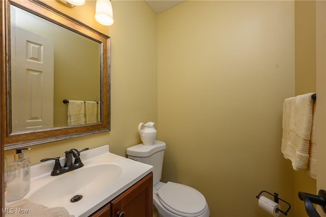 bathroom featuring toilet and vanity