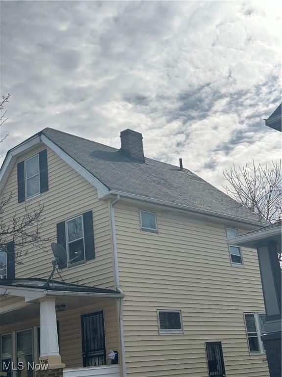 view of property exterior featuring a chimney