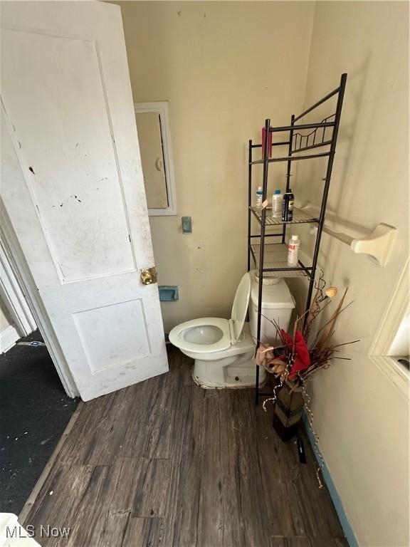 bathroom featuring toilet and wood finished floors