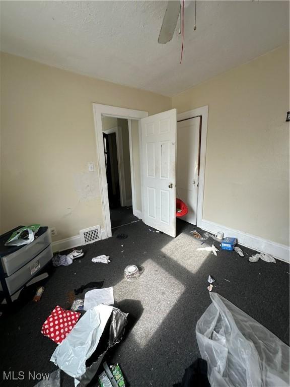 bedroom with a ceiling fan, visible vents, and baseboards