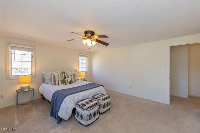 bedroom with baseboards, carpet floors, and a ceiling fan