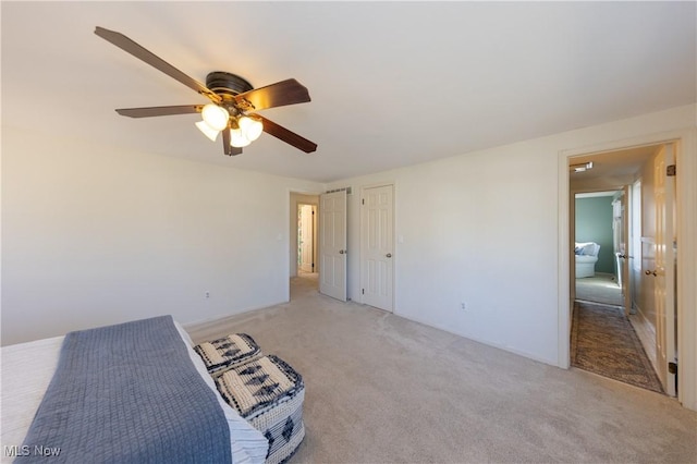 unfurnished bedroom with light colored carpet and ceiling fan