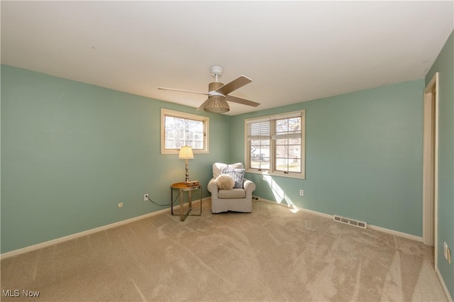 unfurnished room with ceiling fan, carpet, visible vents, and baseboards