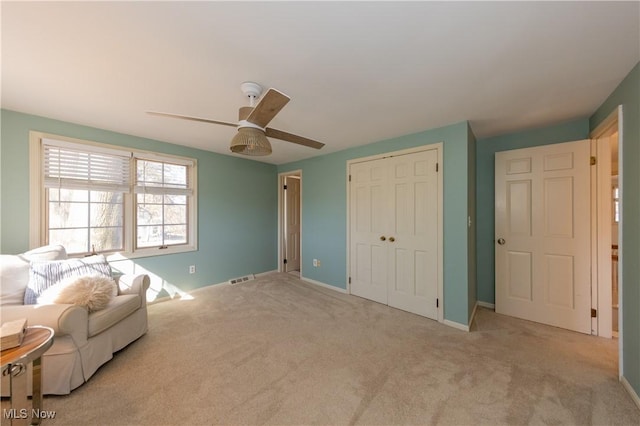 interior space with visible vents, baseboards, a ceiling fan, and carpet floors