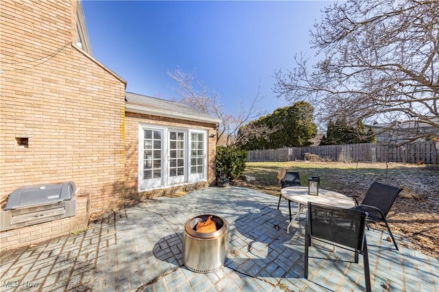 view of patio / terrace featuring a fire pit and fence