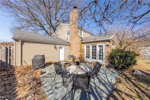 view of patio featuring area for grilling, french doors, outdoor dining area, and fence