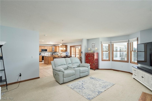 living area with light carpet, recessed lighting, a healthy amount of sunlight, and baseboards