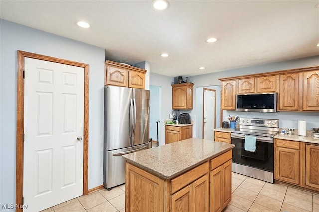 kitchen with recessed lighting, stainless steel appliances, a center island, and light tile patterned floors