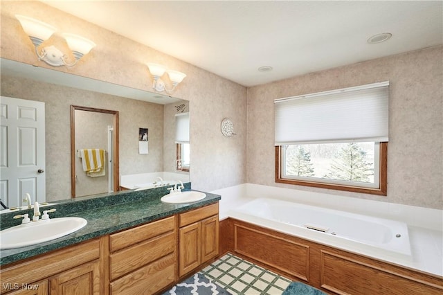 full bath with double vanity, a garden tub, and a sink