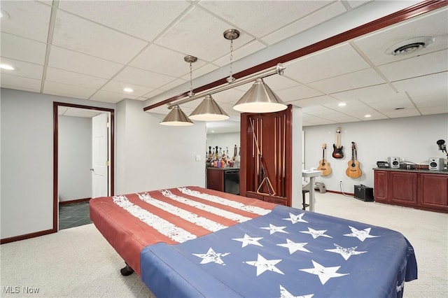 carpeted bedroom featuring recessed lighting, a drop ceiling, baseboards, and visible vents