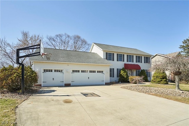 colonial house with a garage and driveway