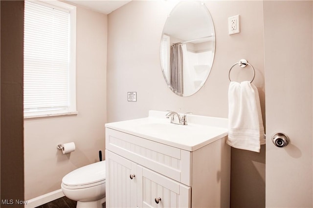2448 Warrensville Center Rd, University Heights, OH 44118 - full bathroom with vanity, toilet, and baseboards