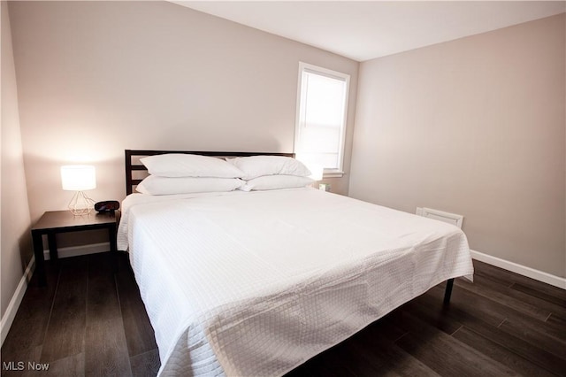 2448 Warrensville Center Rd, University Heights, OH 44118 - bedroom featuring baseboards and wood finished floors