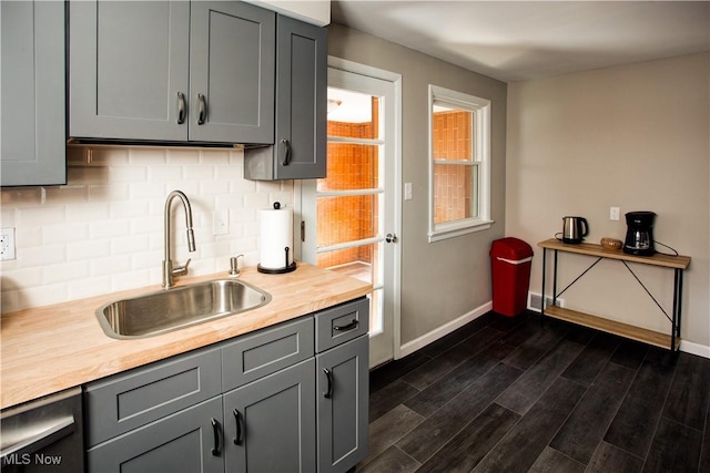2448 Warrensville Center Rd, University Heights, OH 44118 - kitchen with decorative backsplash, gray cabinets, dark wood-type flooring, and a sink