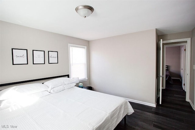 2448 Warrensville Center Rd, University Heights, OH 44118 - bedroom featuring dark wood finished floors and baseboards