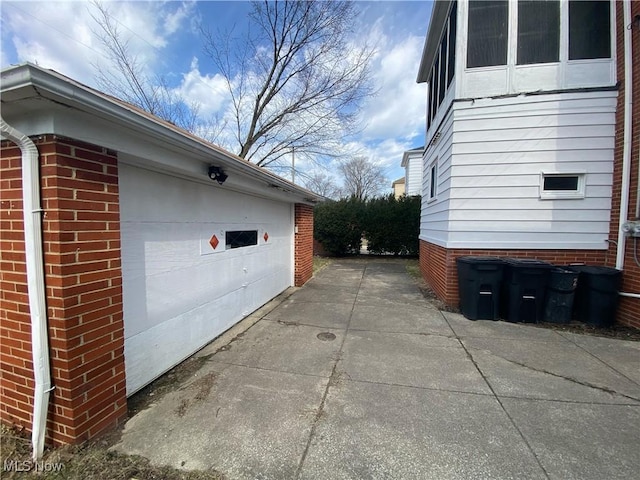 2448 Warrensville Center Rd, University Heights, OH 44118 - view of side of property with a garage and brick siding