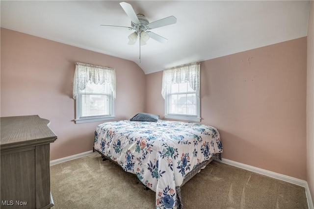 bedroom with vaulted ceiling, carpet, and baseboards