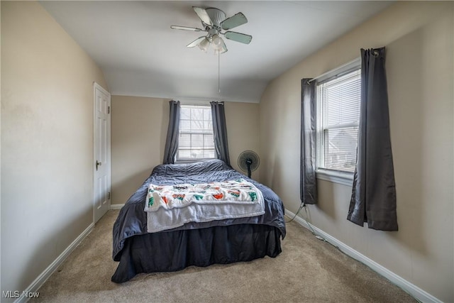 bedroom with carpet flooring, a ceiling fan, lofted ceiling, and baseboards