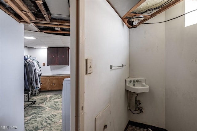 bathroom featuring a paneled ceiling and a sink