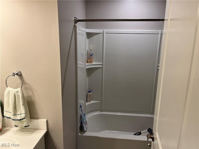 bathroom featuring vanity and  shower combination