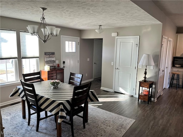 dining area with a healthy amount of sunlight, a textured ceiling, baseboards, and dark wood-style flooring