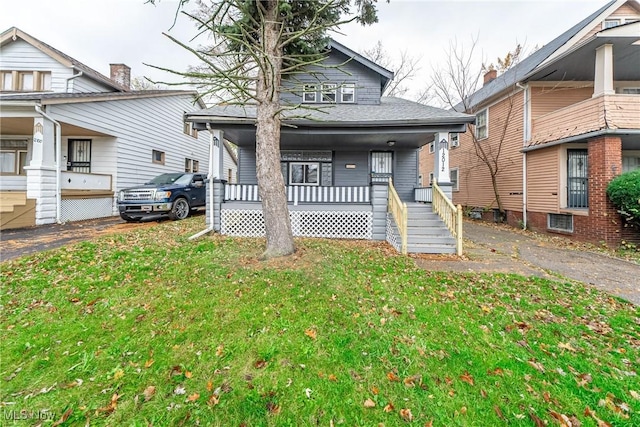 view of front of house with a porch and a front lawn