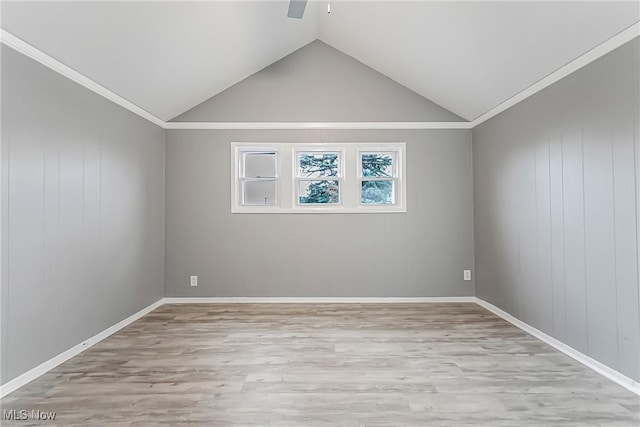 unfurnished room with a ceiling fan, lofted ceiling, and light wood-style floors