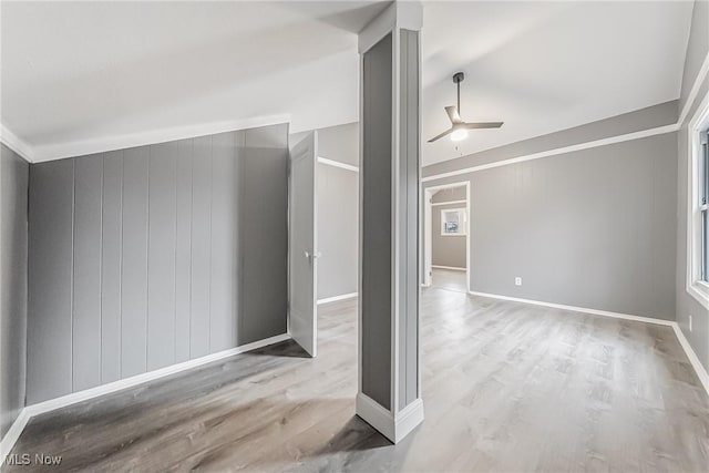 unfurnished room with baseboards, ceiling fan, and wood finished floors