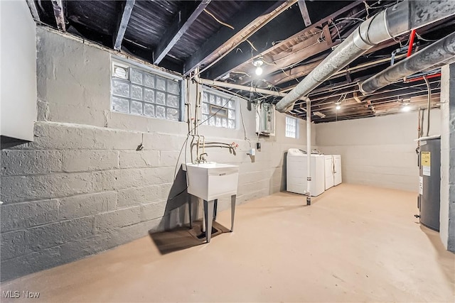 below grade area with washing machine and dryer and electric water heater