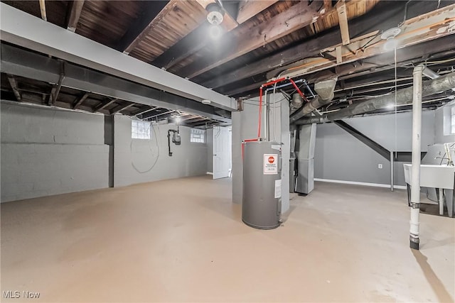 basement featuring heating unit and electric water heater