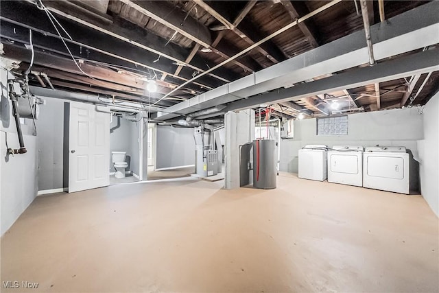 basement with heating unit, independent washer and dryer, and water heater